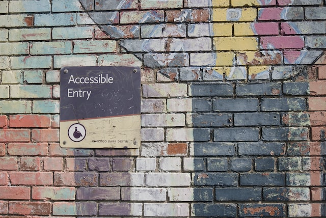 accessible entry signage brick wall